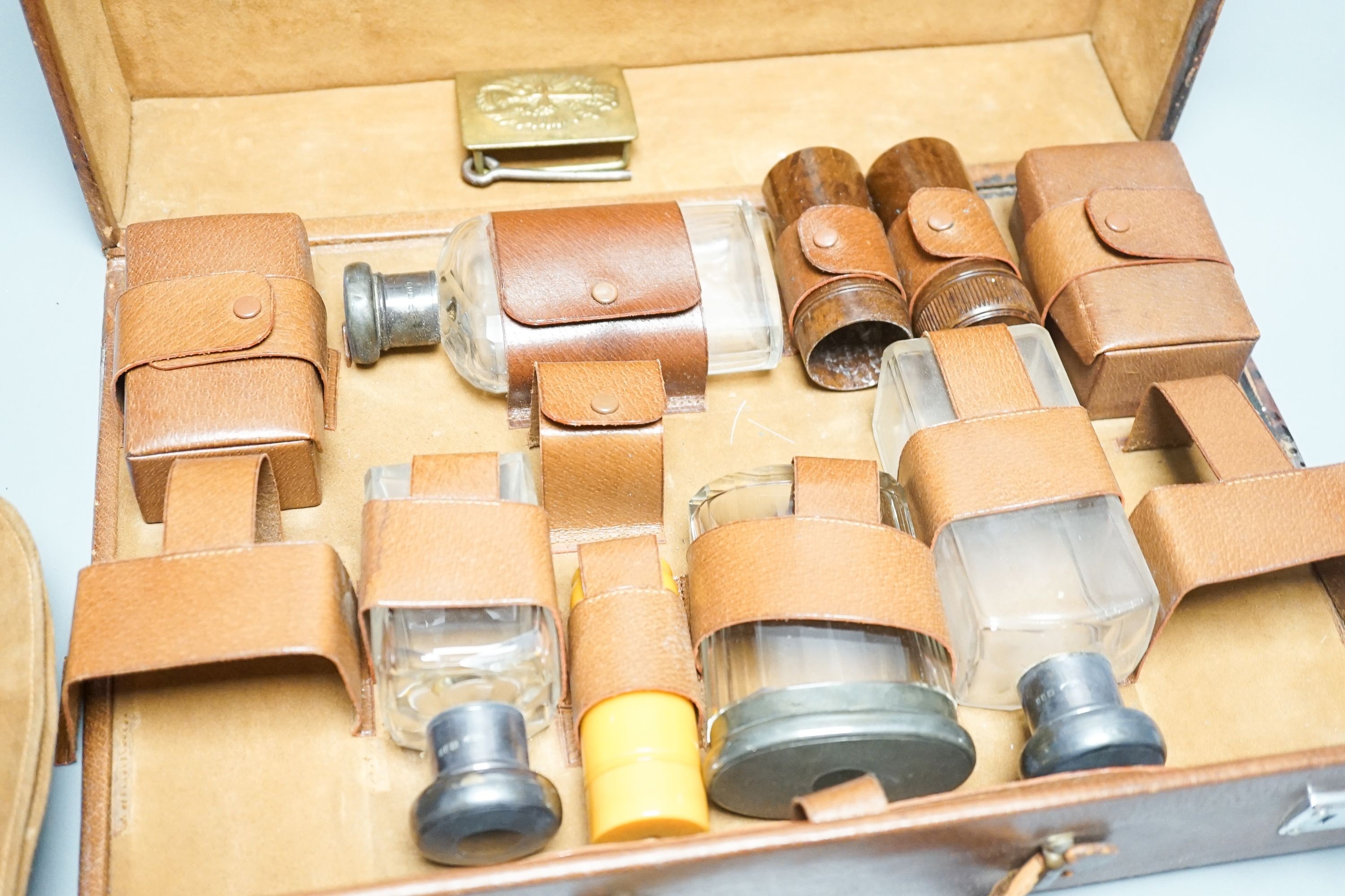 Leather travelling toilet set, some silver lids, and belt.